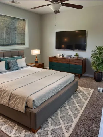 a bedroom with a bed and a flat screen tv