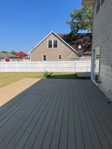a view of backyard with a deck