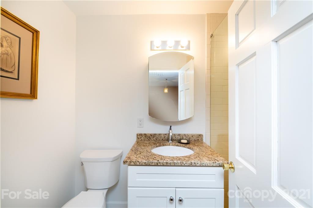 3216 Ferncliff Road Charlotte, NC 28211 - Photo 36 of 47 a bathroom with a granite countertop sink and a mirror