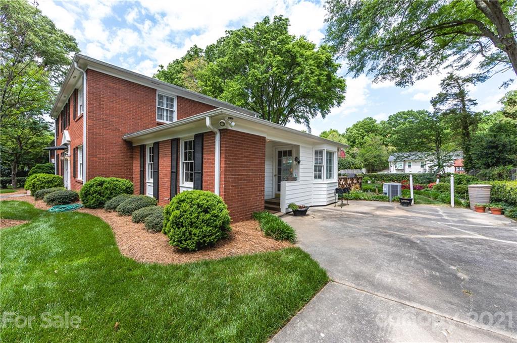 3216 Ferncliff Road Charlotte, NC 28211 - Photo 42 of 47 a view of a house with brick walls plants and large trees