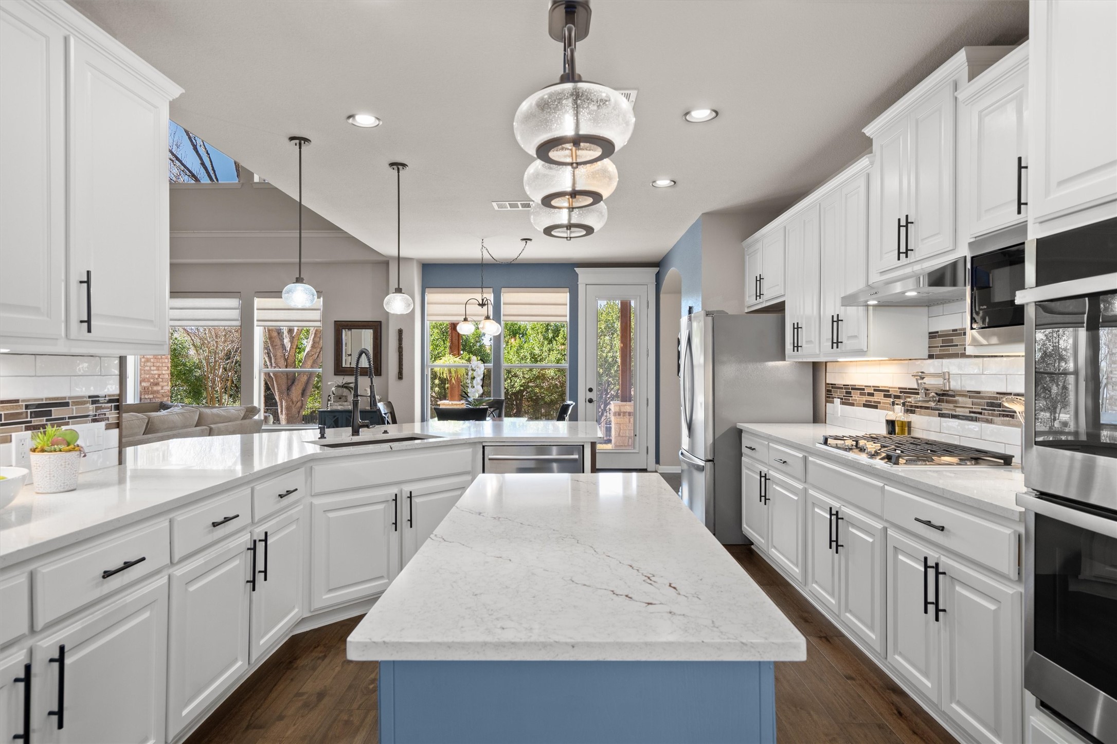 3105 Castellano Way Cedar Park, TX 78613 - Photo 15 of 40 Updated open kitchen featuring beautiful lighting, and an abundance of counter space-ideal for cooking, entertaining, and hosting large gatherings with ample cabinetry and a functional open layout.