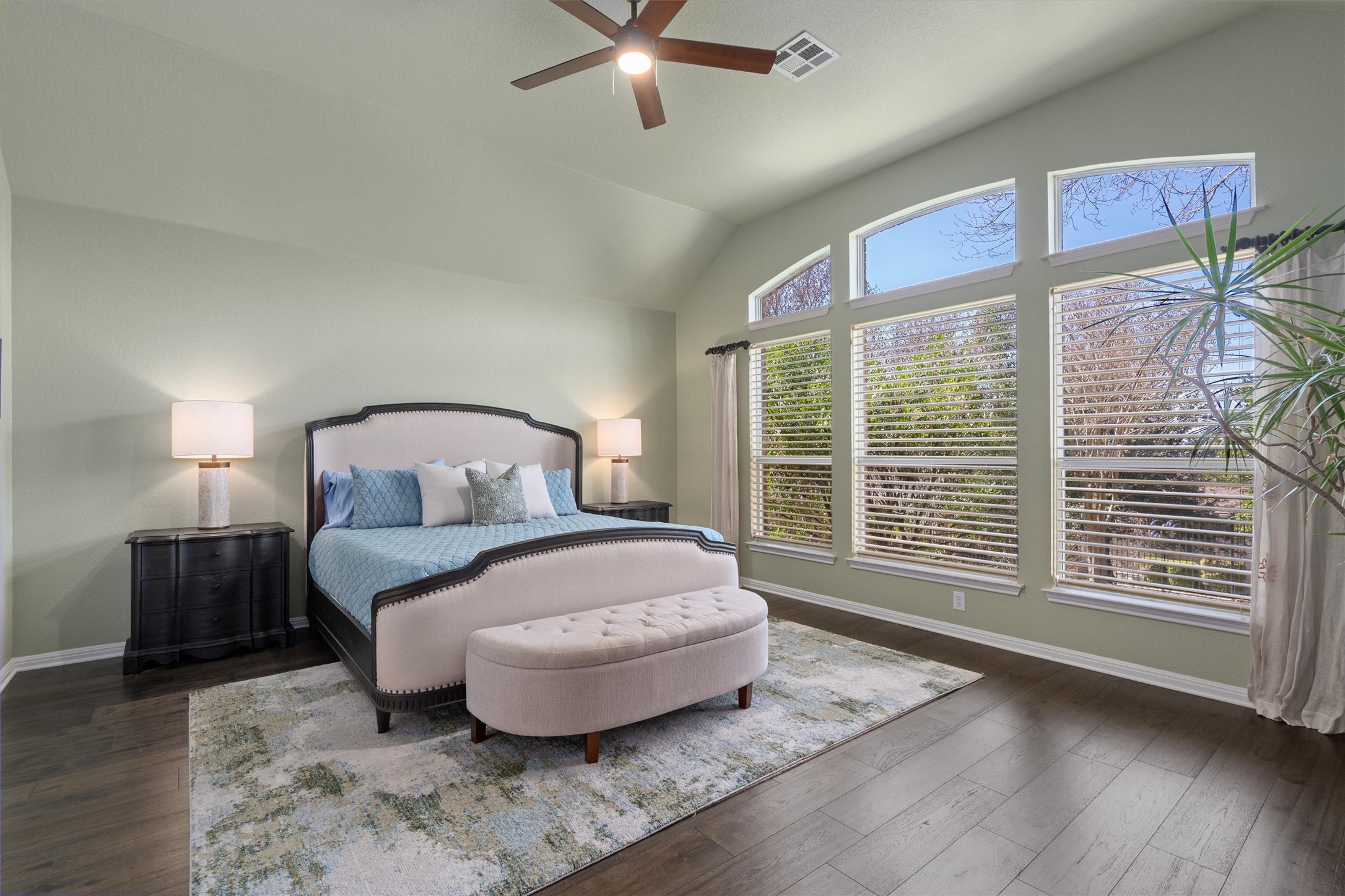 3105 Castellano Way Cedar Park, TX 78613 - Photo 22 of 40 Serene primary bedroom featuring vaulted ceilings, lots of natural light, and large windows overlooking the backyard-an inviting retreat designed for comfort and relaxation