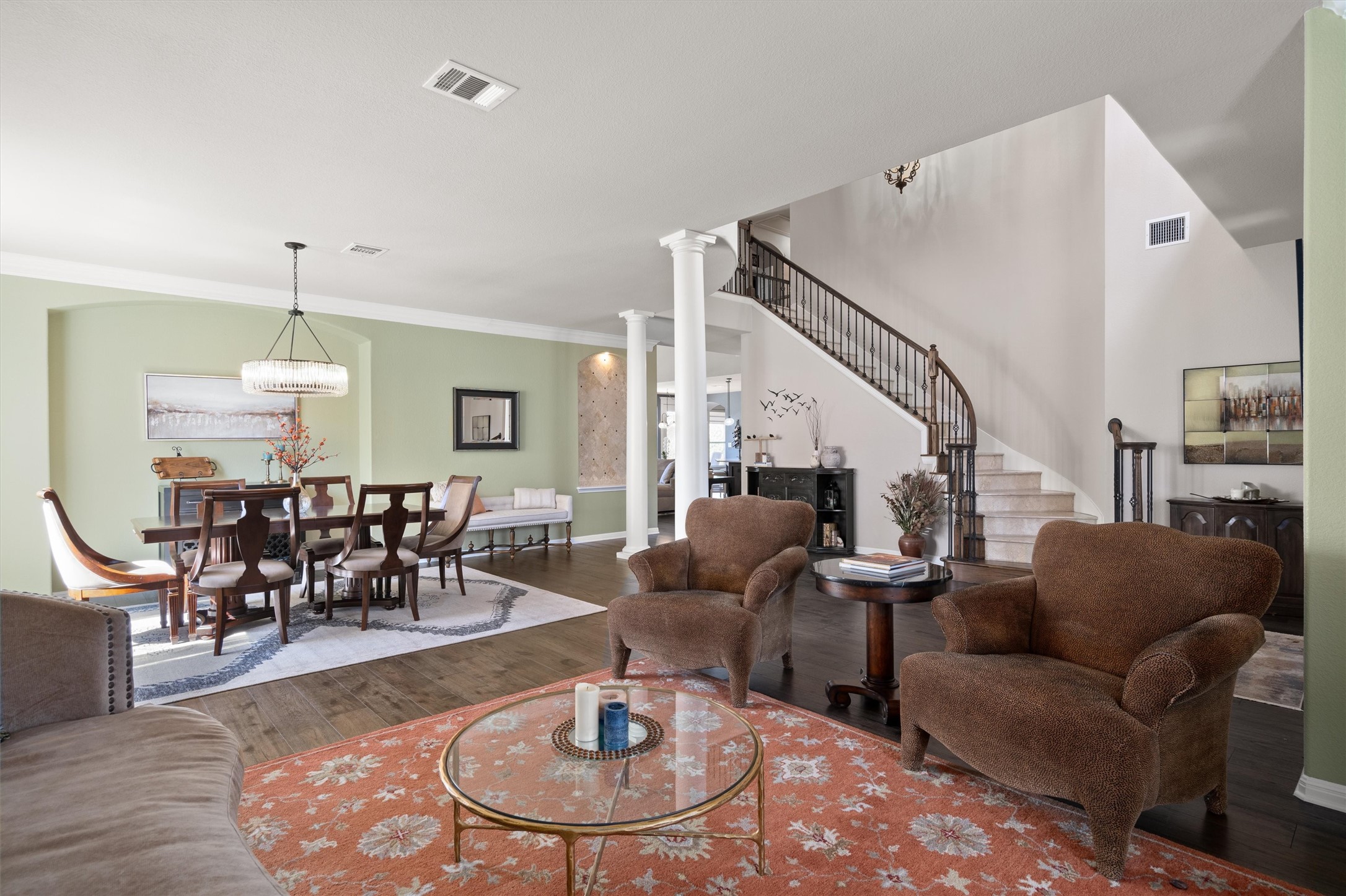 3105 Castellano Way Cedar Park, TX 78613 - Photo 5 of 40 Grand formal and dining area with a statement chandelier, anchored by a sweeping staircase that creates an impressive first view upon entering the home.