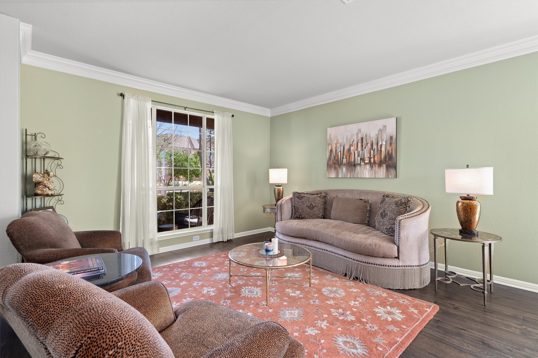 3105 Castellano Way Cedar Park, TX 78613 - Photo 6 of 40 Formal Living room featuring beautiful crown molding. wood finished floors, and abundant natural light from the large windows. An inviting space ideal for entertaining or quiet conversations.