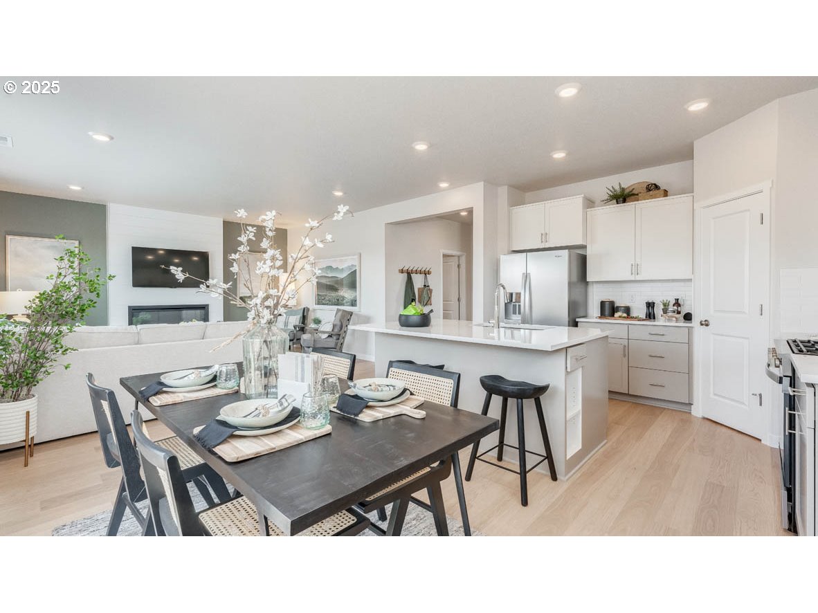 3609 Main Street Forest Grove, OR 97116 - Photo 10 of 29 a open kitchen with a dining table chairs and kitchen island