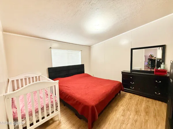 a bedroom with a bed and a large window