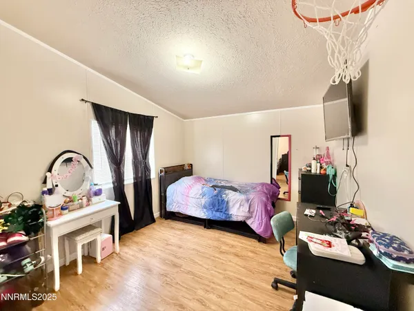 a bedroom with furniture and a flat screen tv
