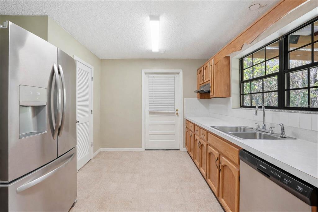 596 Highway 20 Palatka, FL 32177 - Photo 27 of 49 a kitchen with granite countertop a refrigerator and a sink