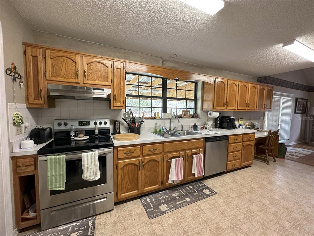 596 Highway 20 Palatka, FL 32177 - Photo 28 of 49 a kitchen with stainless steel appliances granite countertop a stove a sink and a microwave