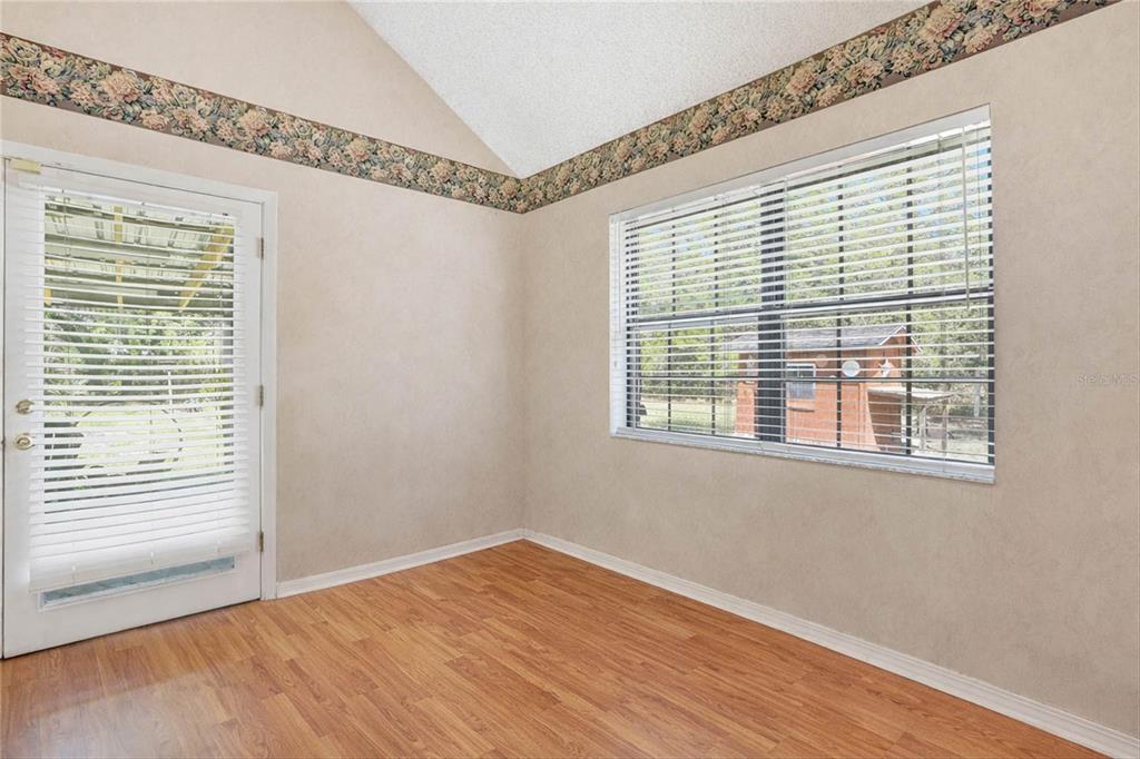 596 Highway 20 Palatka, FL 32177 - Photo 29 of 49 a view of an empty room with wooden floor and a window