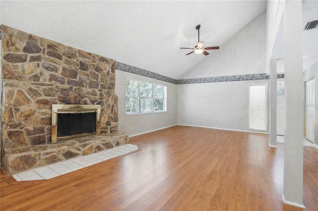 596 Highway 20 Palatka, FL 32177 - Photo 31 of 49 wooden floor in an empty room with a fireplace