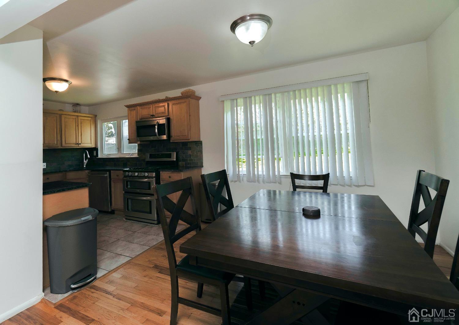 26 Phillips Road Edison, NJ 08817 - Photo 12 of 27 a view of a dining room with furniture and wooden floor