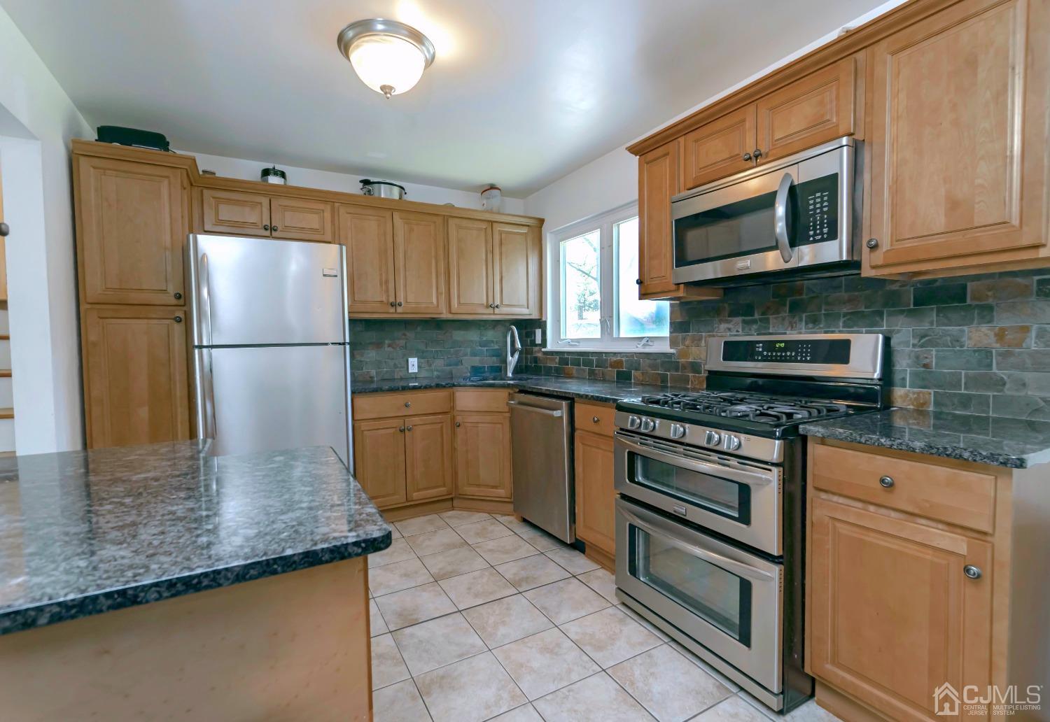 26 Phillips Road Edison, NJ 08817 - Photo 14 of 27 a kitchen with stainless steel appliances granite countertop a refrigerator sink and microwave