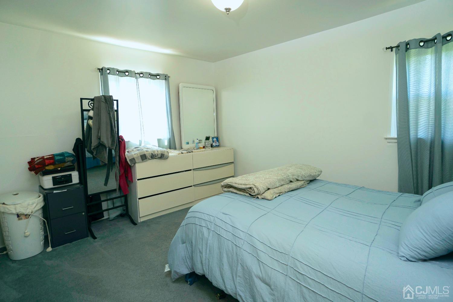 26 Phillips Road Edison, NJ 08817 - Photo 15 of 27 a bedroom with a bed and a mirror