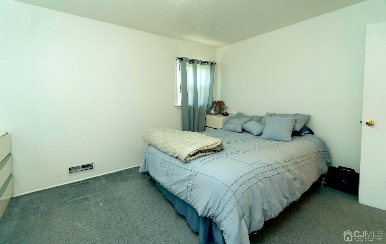 26 Phillips Road Edison, NJ 08817 - Photo 16 of 27 a bedroom with a bed and window