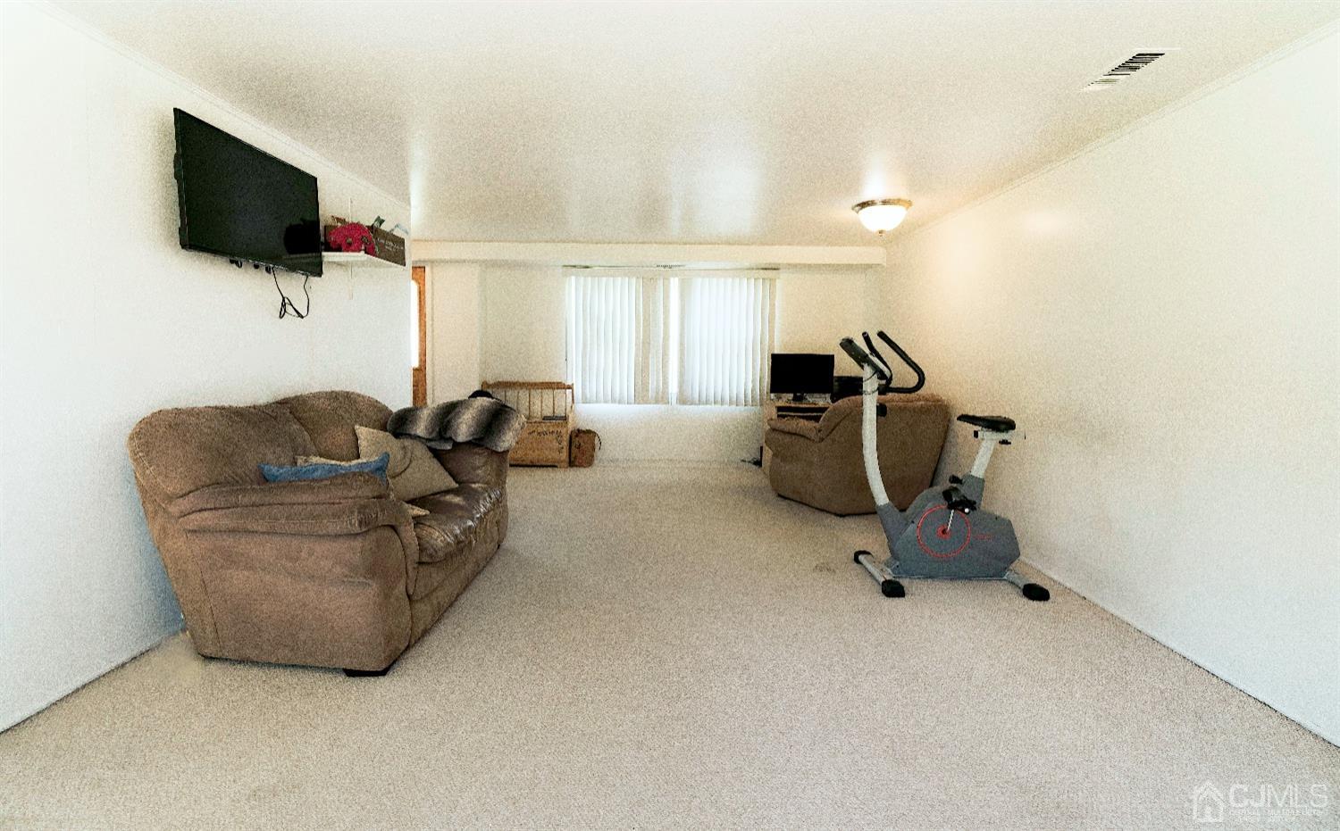 26 Phillips Road Edison, NJ 08817 - Photo 5 of 27 a living room with furniture and a flat screen tv