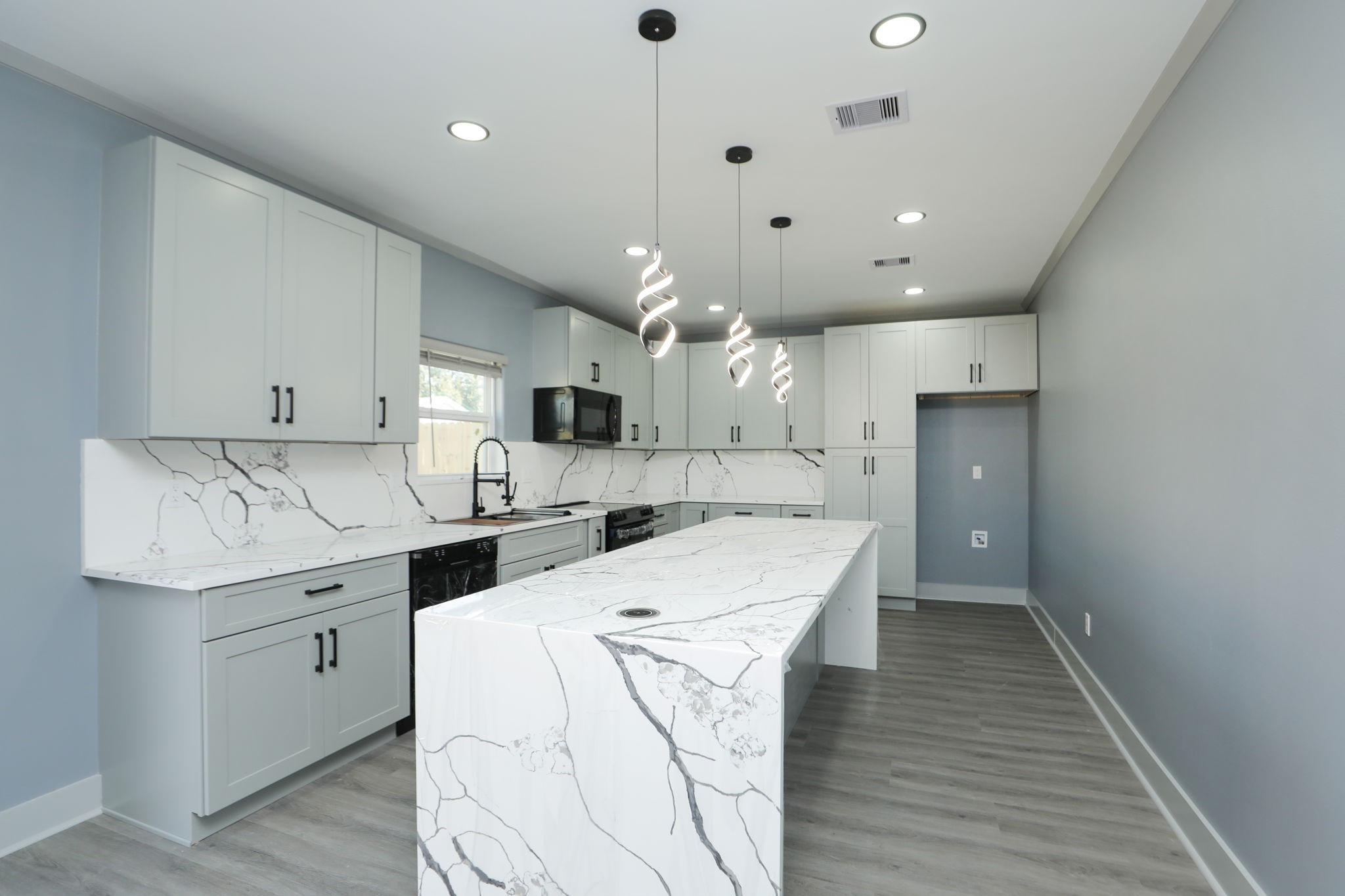 4047 Juliet Street Houston, TX 77087 - Photo 11 of 38 a kitchen with cabinets and wooden floor