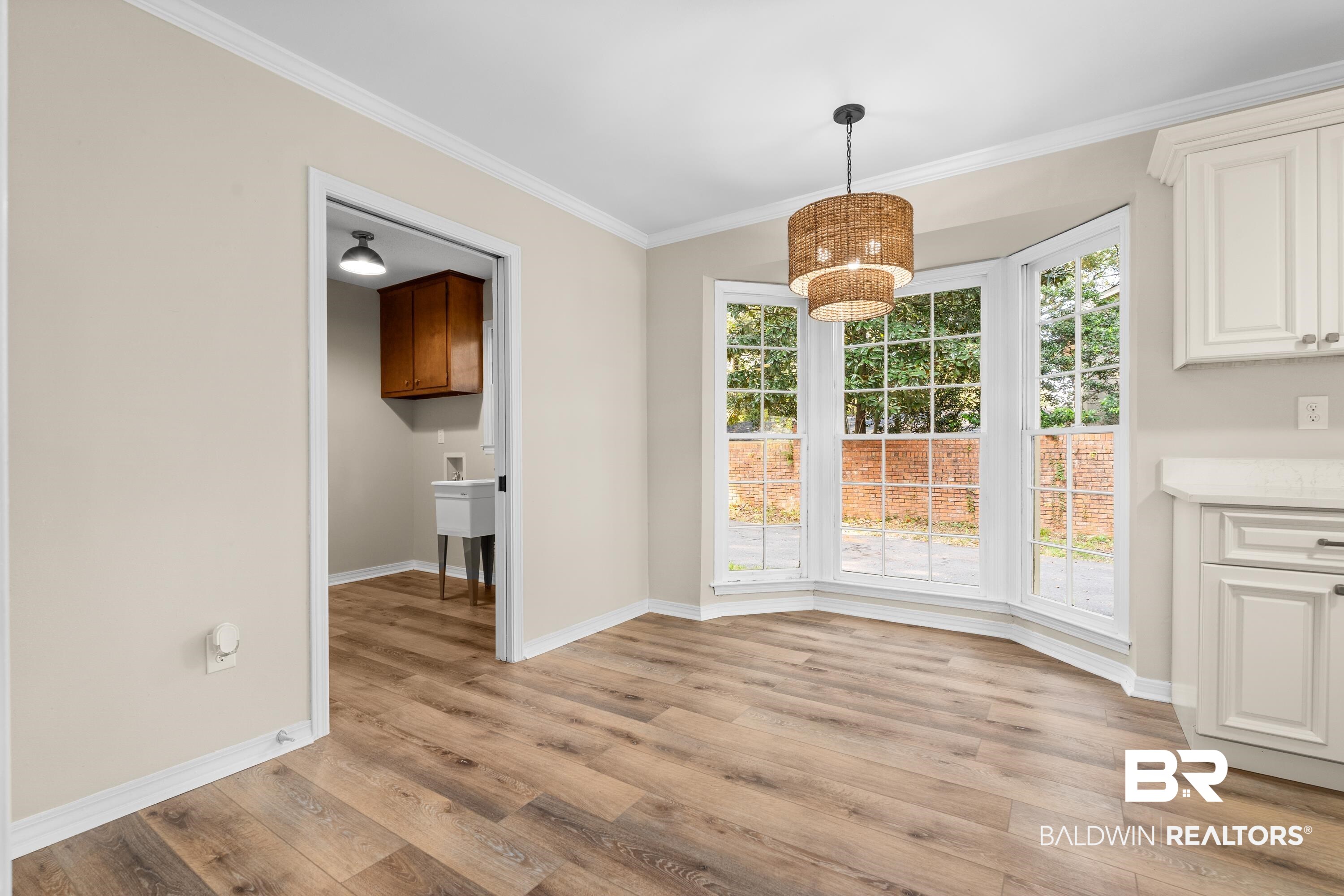 728 Spring Station Road Mobile, AL 36609 - Photo 10 of 35 Unfurnished dining area with ornamental molding and light wood-type flooring