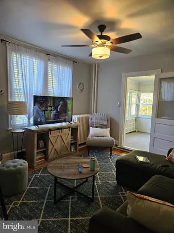 a living room with furniture and a chandelier