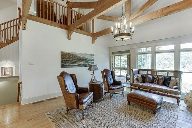 a dining room with furniture a chandelier and wooden floor