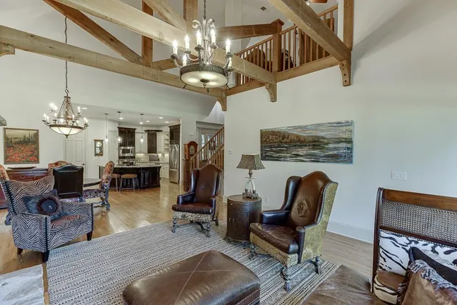 a kitchen with refrigerator a sink and chairs