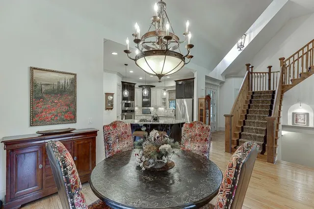 a bathroom with a granite countertop sink vanity mirror and toilet