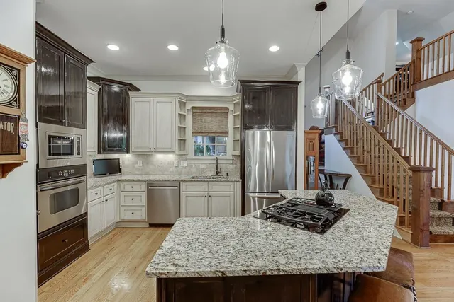 a bedroom with a large bed and a chandelier