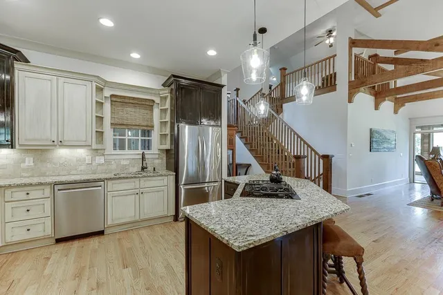 a bedroom with a large bed a flat tv screen and dresser