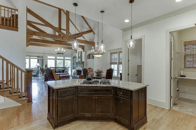 a spacious bathroom with a granite countertop sink a mirror a shower and a bathtub
