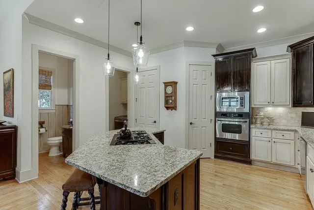 a spacious bathroom with a granite countertop tub a double vanity sink a window and a mirror