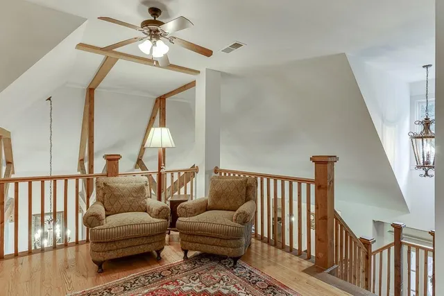 a bedroom with bed and a chandelier