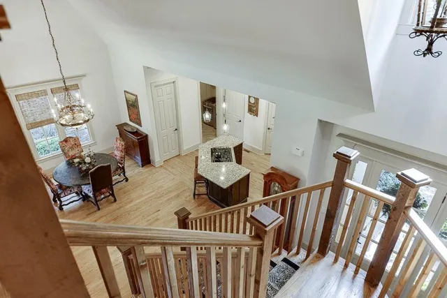 a view of a lake with a floor to ceiling window next to a yard