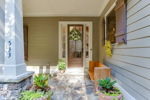 a living room with furniture a chandelier and a rug