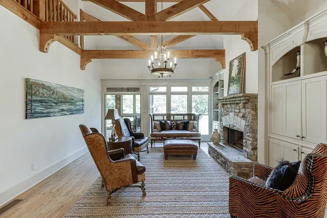 a dining room with furniture a chandelier and wooden floor
