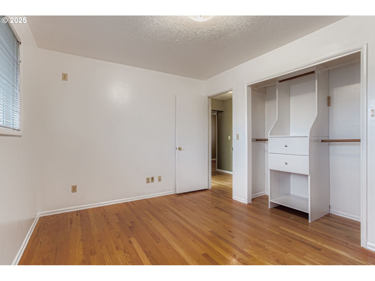 10832 Southeast Stephens Street Portland, OR 97216 - Photo 14 of 36 a view of an empty room with wooden floor and cabinet