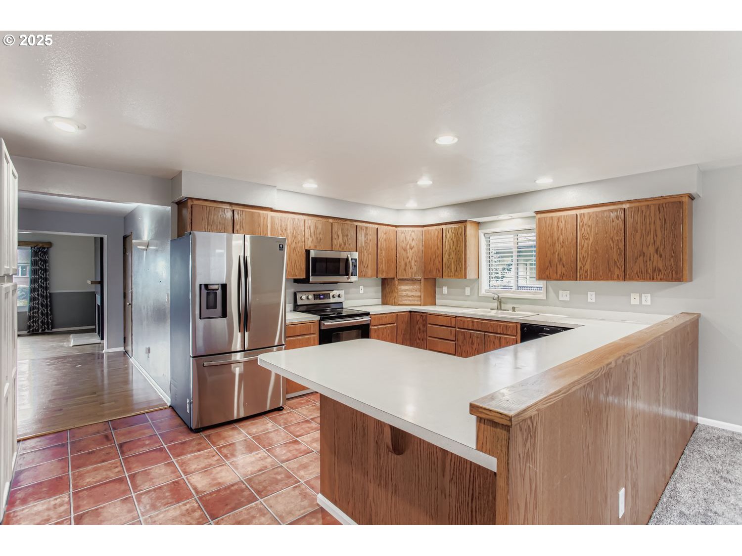 10832 Southeast Stephens Street Portland, OR 97216 - Photo 8 of 36 a kitchen with stainless steel appliances a refrigerator and a stove
