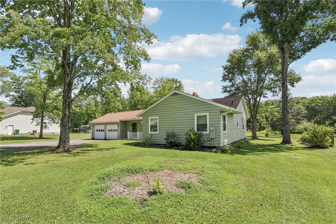 5097 Chillicothe Road Chagrin Falls, OH 44022 - Photo 35 of 45 View of home's exterior with an attached garage, driveway, and a yard