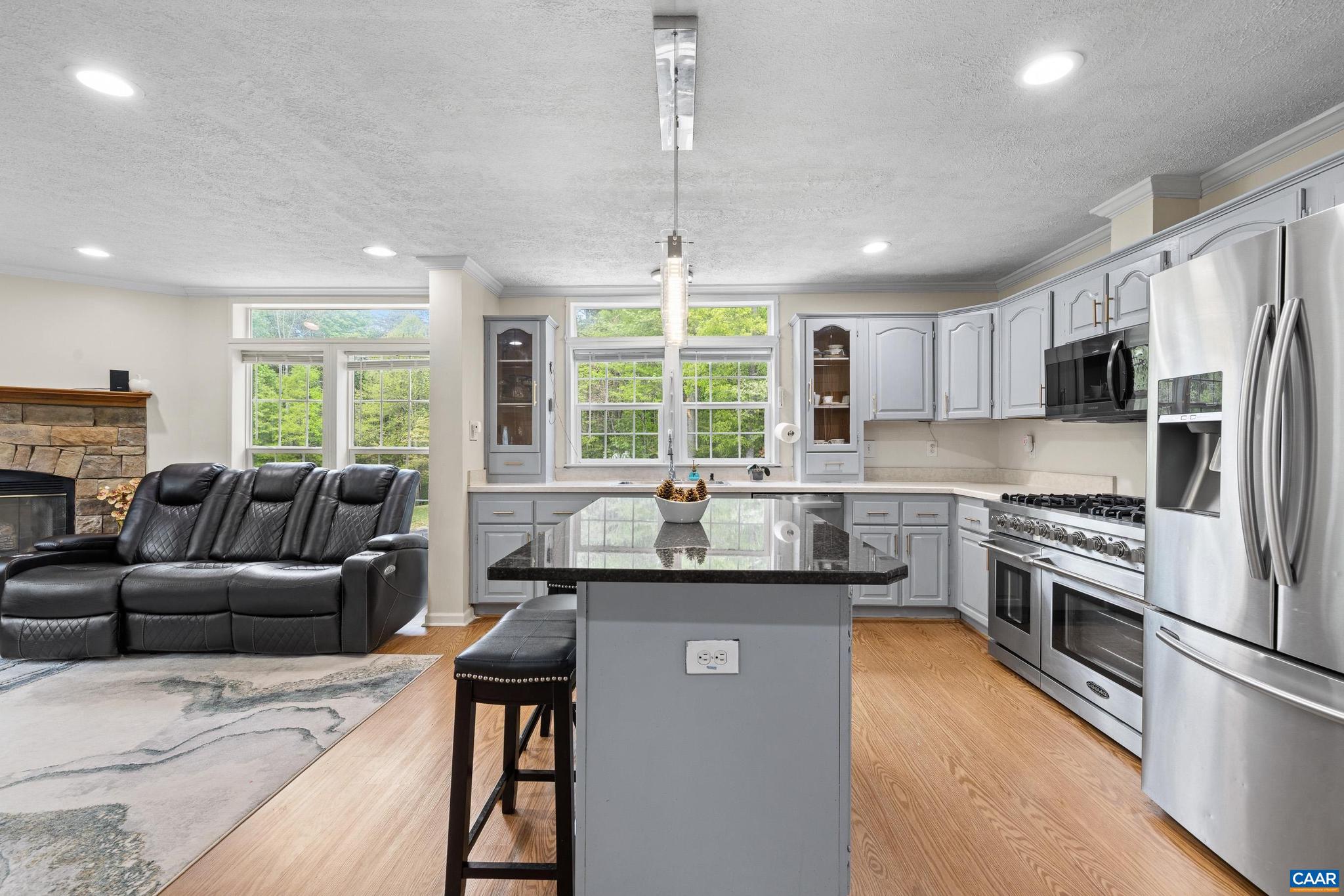3151 Waldrop Church Road Louisa, VA 23093 - Photo 18 of 42 a kitchen with stainless steel appliances granite countertop a stove sink refrigerator and window
