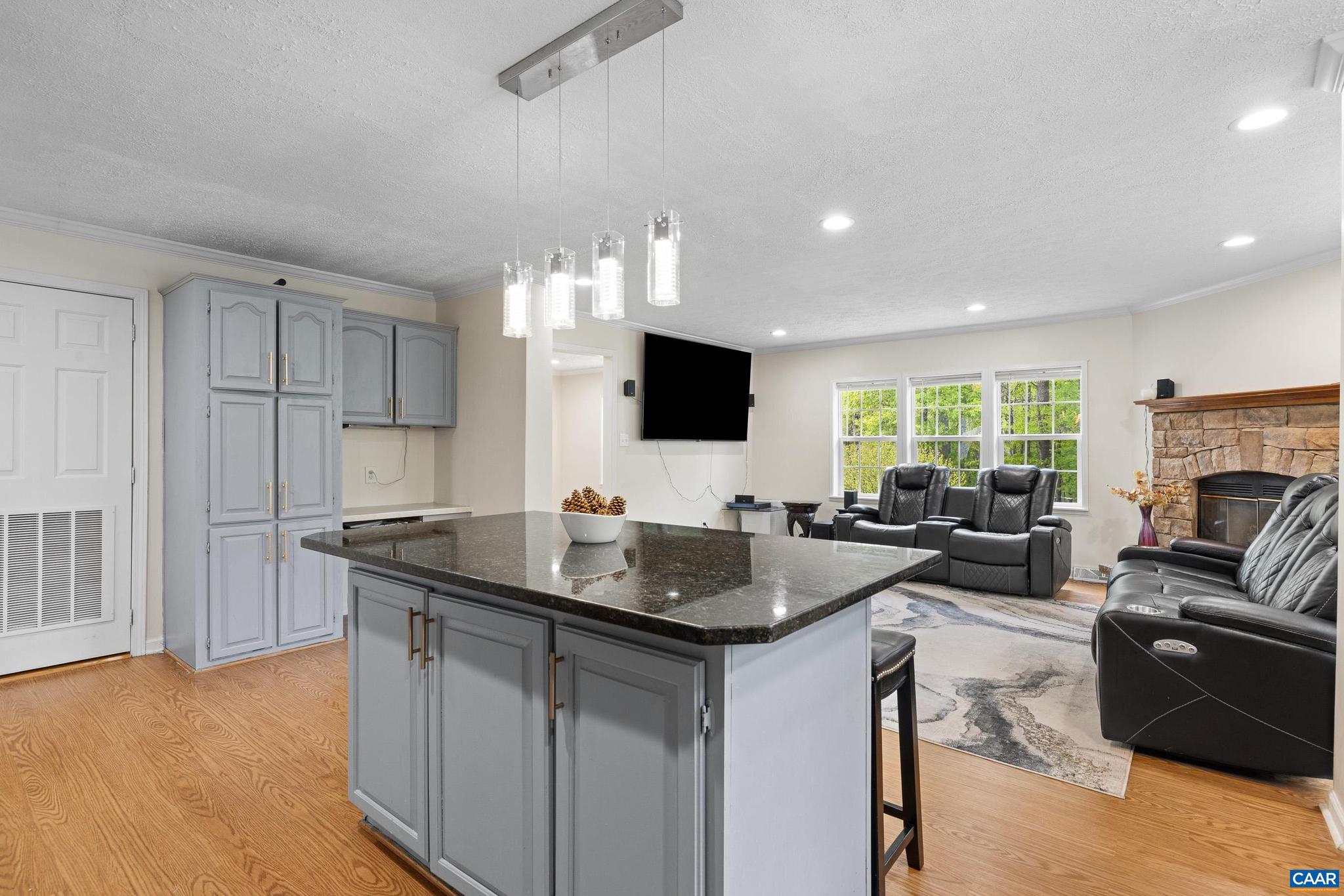 3151 Waldrop Church Road Louisa, VA 23093 - Photo 19 of 42 a kitchen with granite countertop a sink and a stove top oven with wooden floor