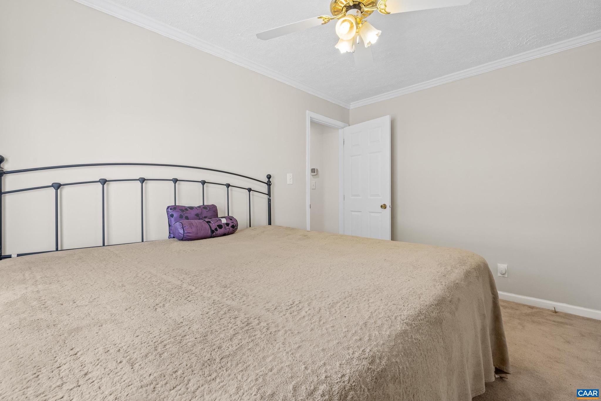 3151 Waldrop Church Road Louisa, VA 23093 - Photo 25 of 42 a bedroom with a bed and a chandelier