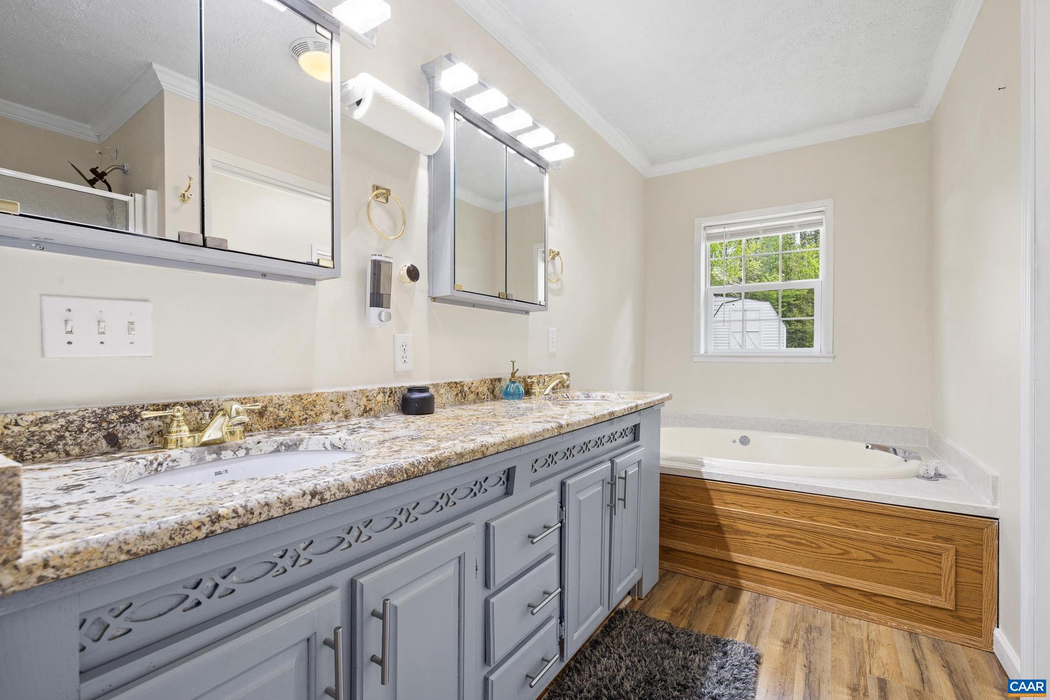 3151 Waldrop Church Road Louisa, VA 23093 - Photo 31 of 42 a bathroom with a granite countertop sink mirror and bathtub