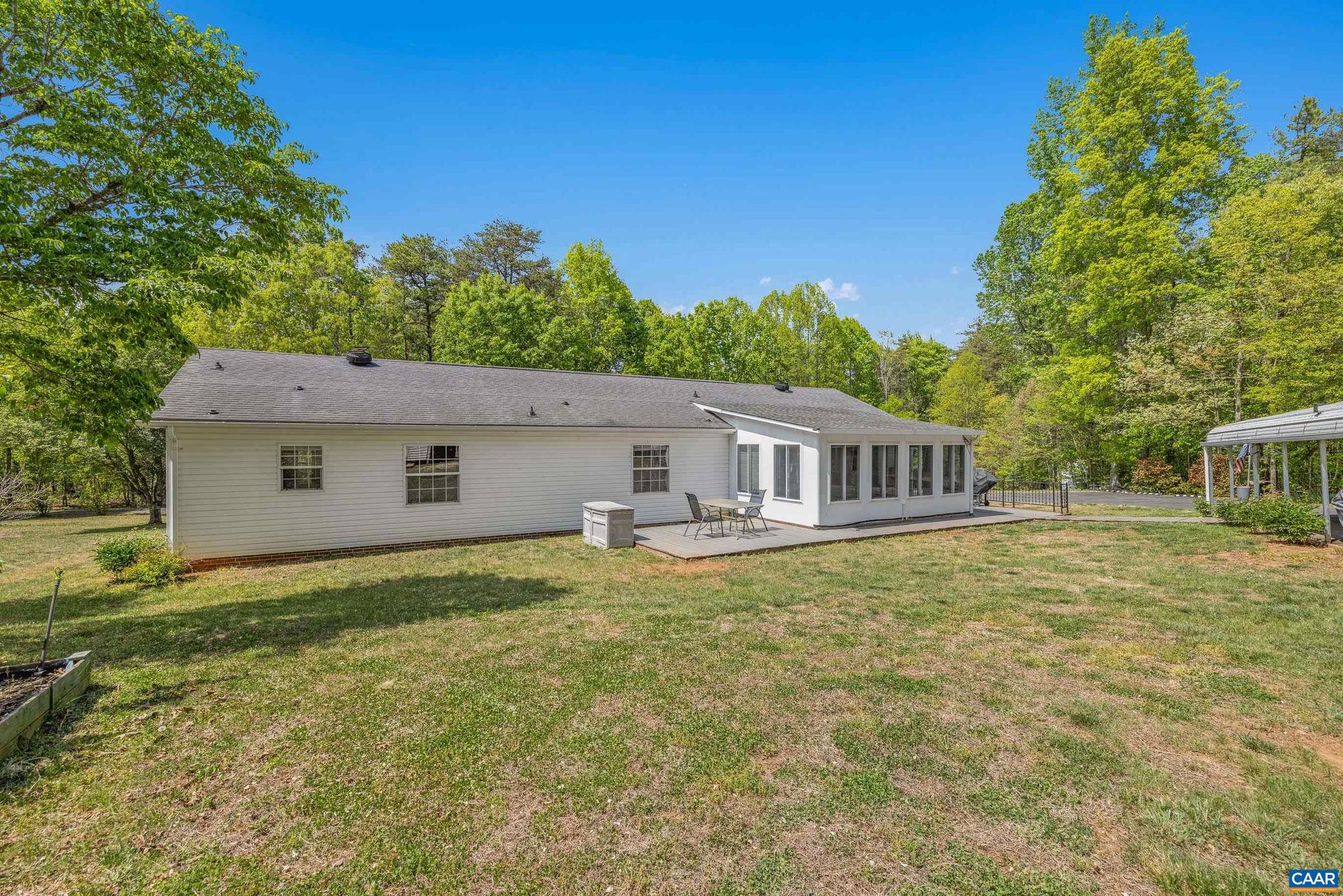 3151 Waldrop Church Road Louisa, VA 23093 - Photo 38 of 42 a house that is sitting in the grass with large trees and plants