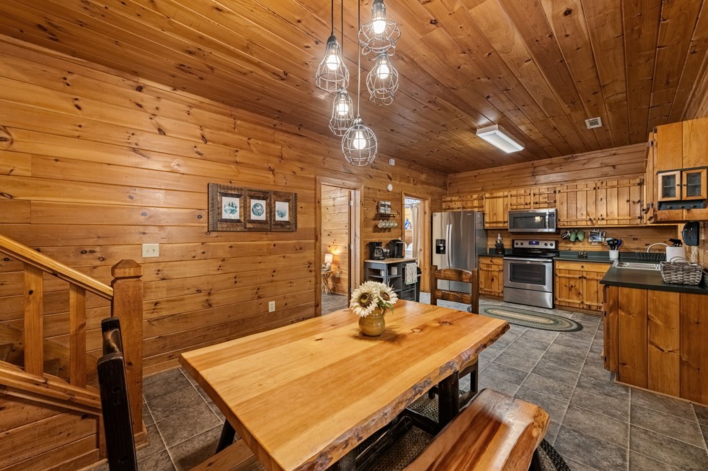196 Ethan Wilson Way Morganton, GA 30560 - Photo 18 of 66 a room with stainless steel appliances kitchen island granite countertop a sink and cabinets