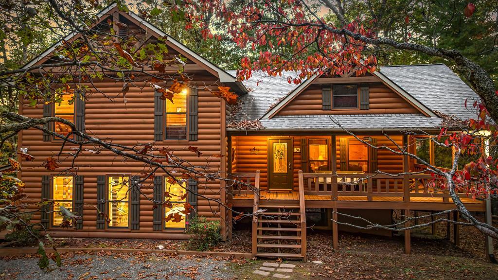 196 Ethan Wilson Way Morganton, GA 30560 - Photo 2 of 66 a roof deck with table and chairs under an umbrella