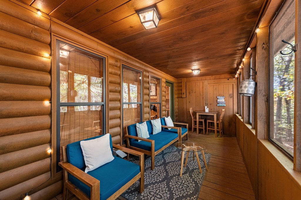 196 Ethan Wilson Way Morganton, GA 30560 - Photo 34 of 66 a living room with furniture a ceiling fan and a rug