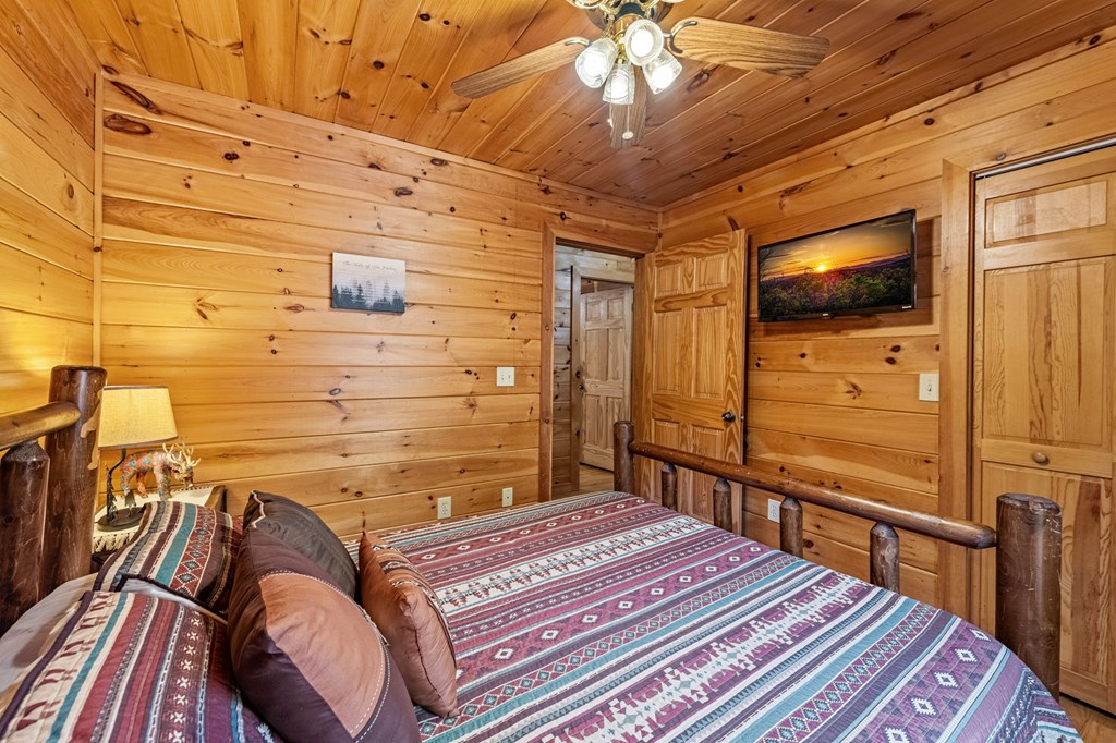 196 Ethan Wilson Way Morganton, GA 30560 - Photo 49 of 66 a bedroom with a bed and a flat screen tv