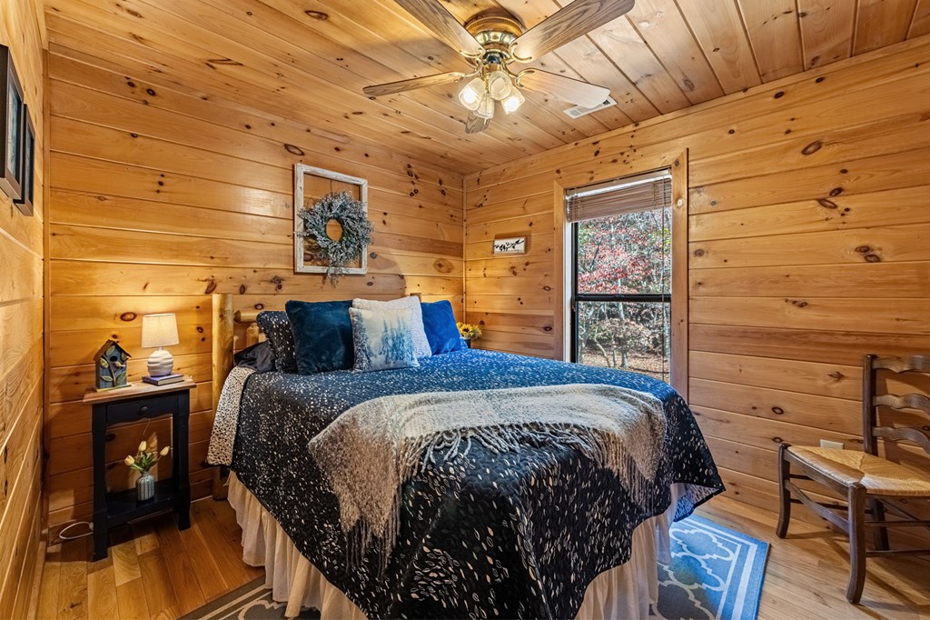 196 Ethan Wilson Way Morganton, GA 30560 - Photo 53 of 66 a bed sitting in a bedroom next to a bathroom