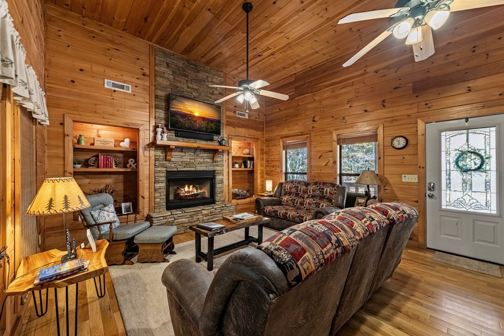 196 Ethan Wilson Way Morganton, GA 30560 - Photo 7 of 66 a living room with furniture a flat screen tv and a fireplace