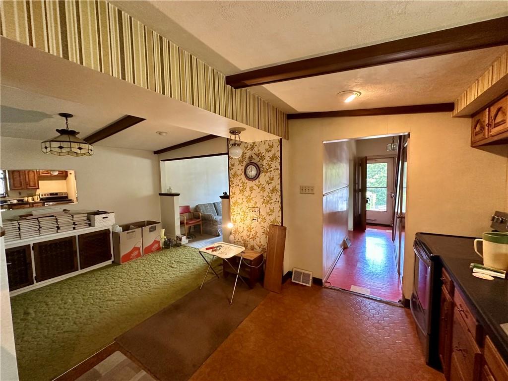 741 Frederick Street McKees Rocks, PA 15136 - Photo 6 of 18 a living room with furniture a flat screen tv and a table