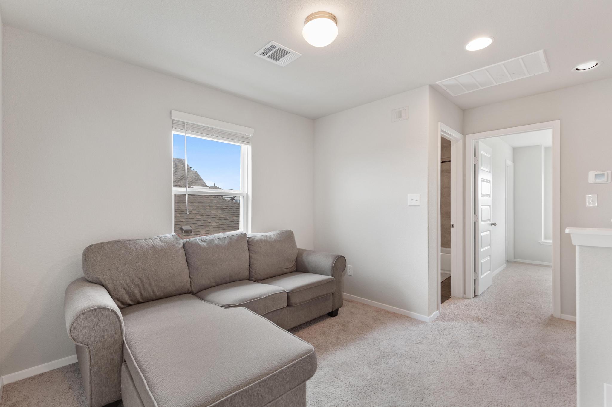 242 Barley Lane Elgin, TX 78621 - Photo 17 of 31 Upper-level room with light-toned carpeting and neutral wall paint
